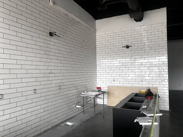 A tall white subway tile wall set with tight grout lines